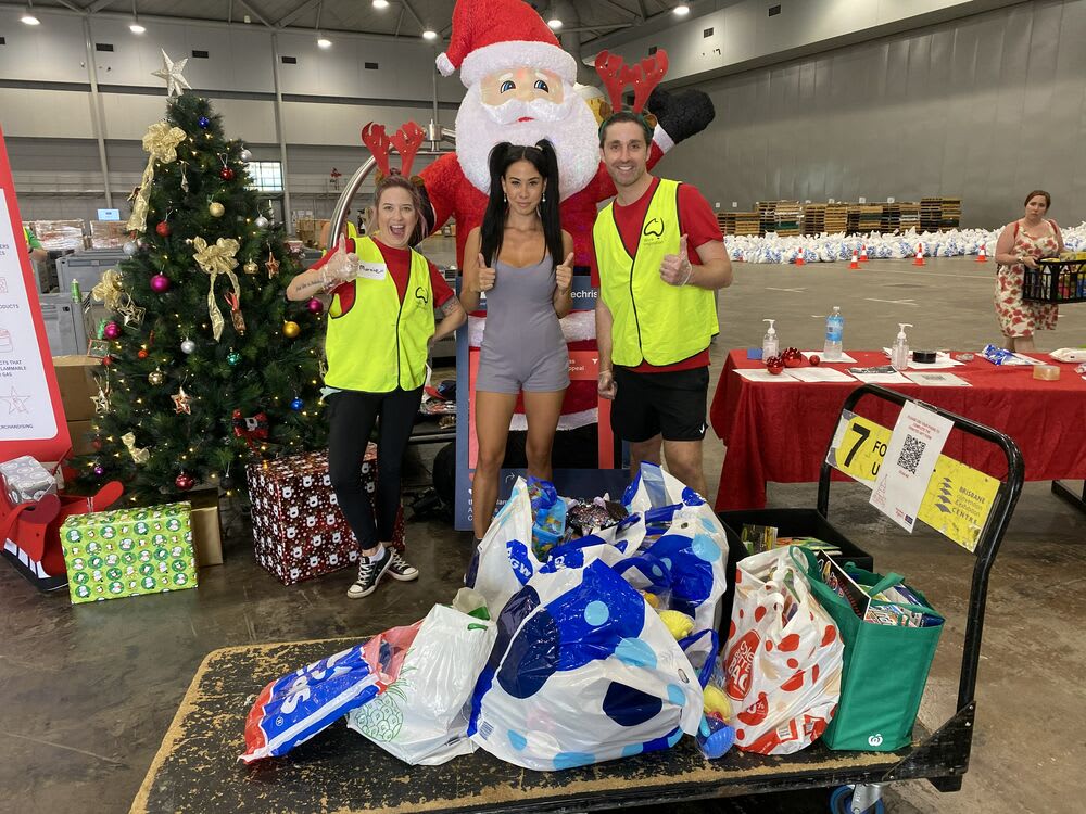 Lexi donating toys and books for children at the Brisbane Convention Centre.