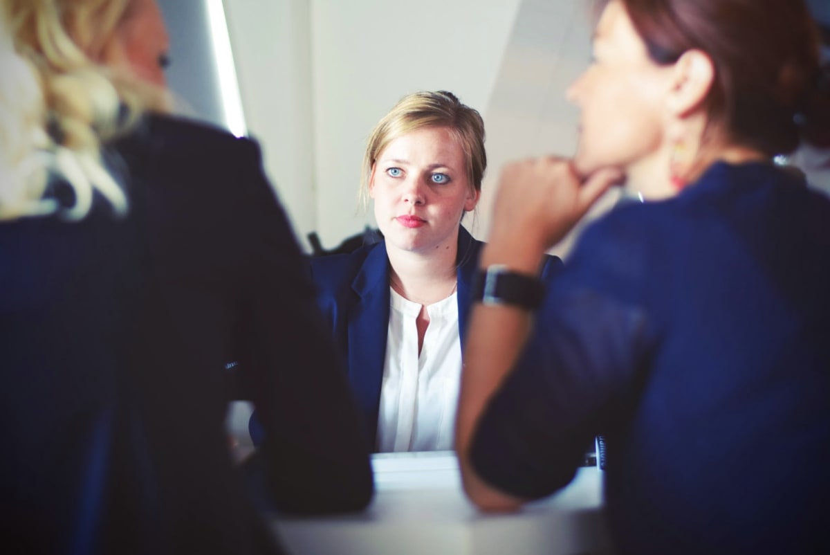 Woman sitting in a meeting with HR, representing workplace bullying