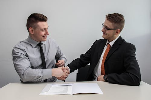 Two businessmen shaking hands after a job interview. 