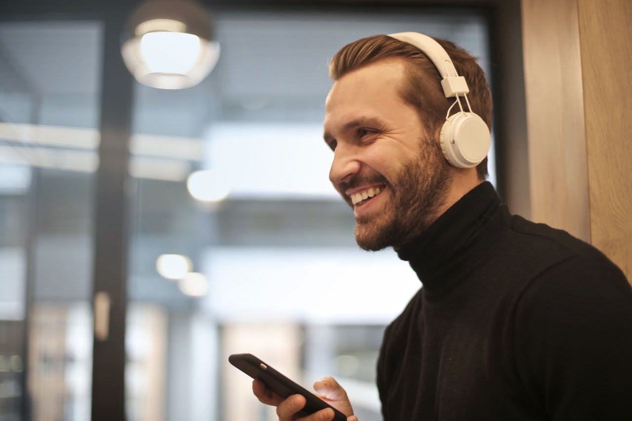Man wearing headphones and smiling