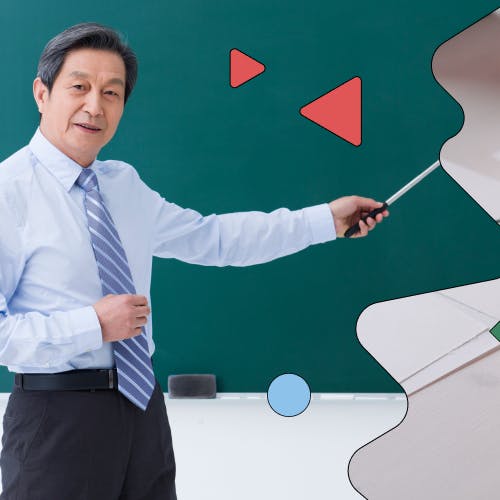 Teacher pointing at a blackboard, indicating learning styles