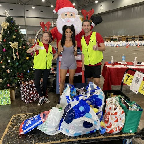 Lexi donating toys and books for children at the Brisbane Convention Centre.