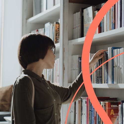 Woman choosing books in a library