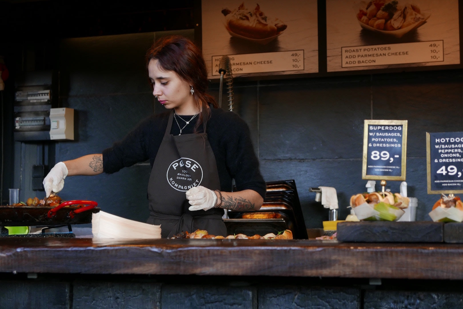 Woman preparing food in a cafe, representing foor safety and hygiene 