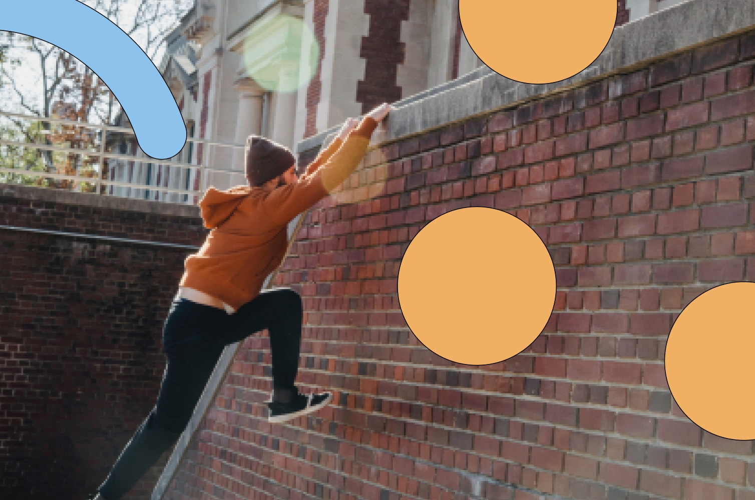 Person climbing over brick wall