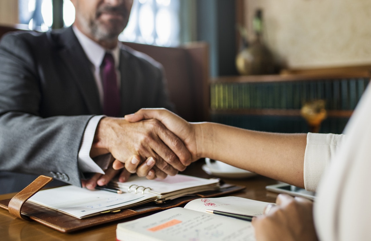 Two people shaking hands in a business setting