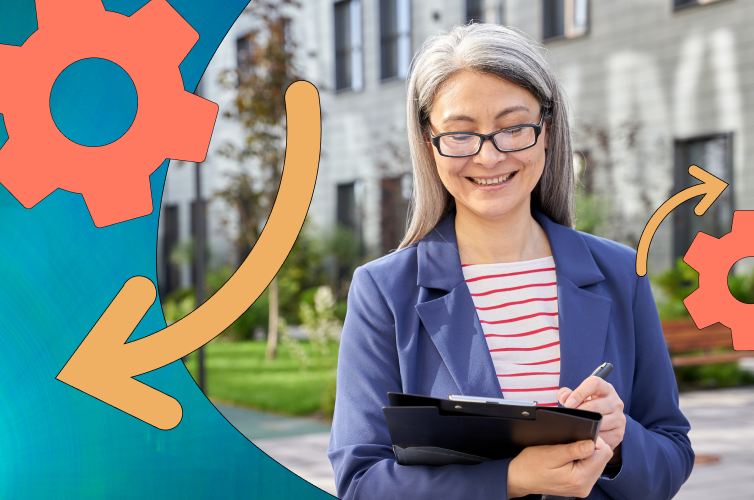 Woman with glasses standing outside, looking at a clipboard