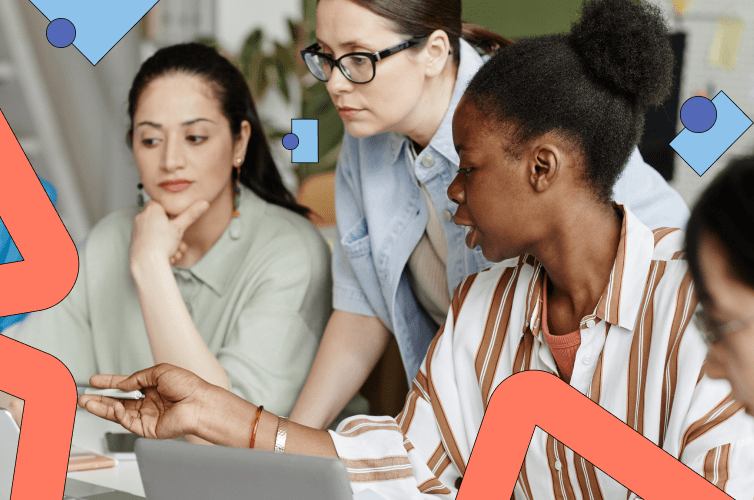 Four people sitting at a table looking at a screen