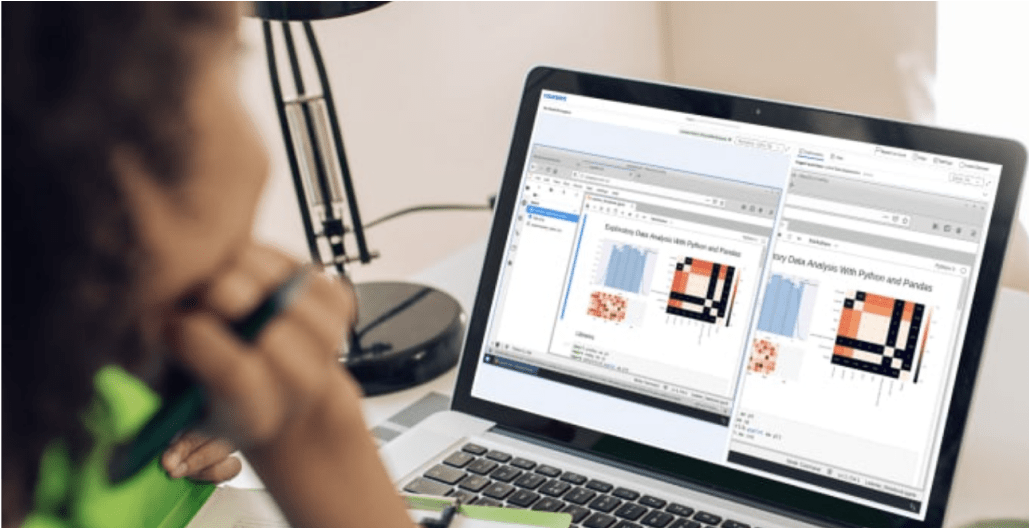 Woman staring at an open laptop screen on her desk